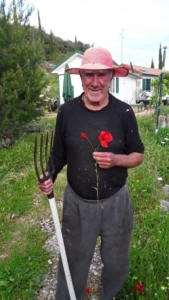 man holding garden rake and flower