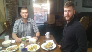 Two men eating dinner