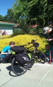 Two men fixing a flat tire on a bicycle