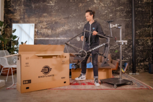 Person disassembling bike to load into BikeFlights bike shipping box