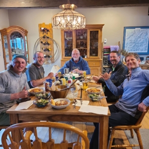 A group of people sitting around a dining room table