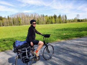 A person on a bicycle on a trail through the woods