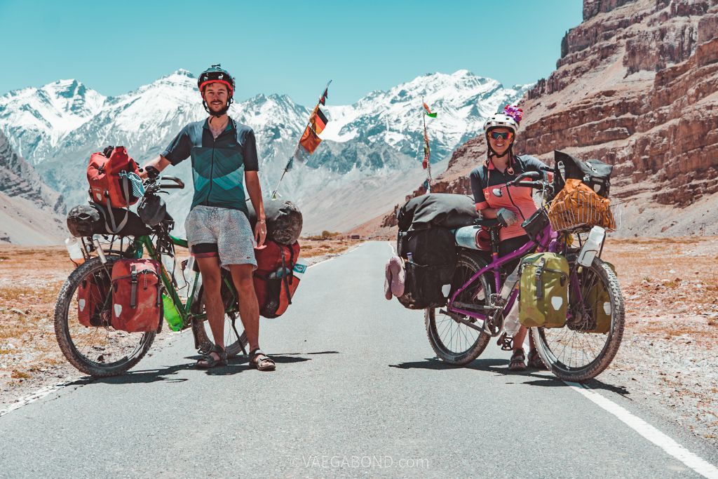 Two people and their touring bicycles on a mountain road